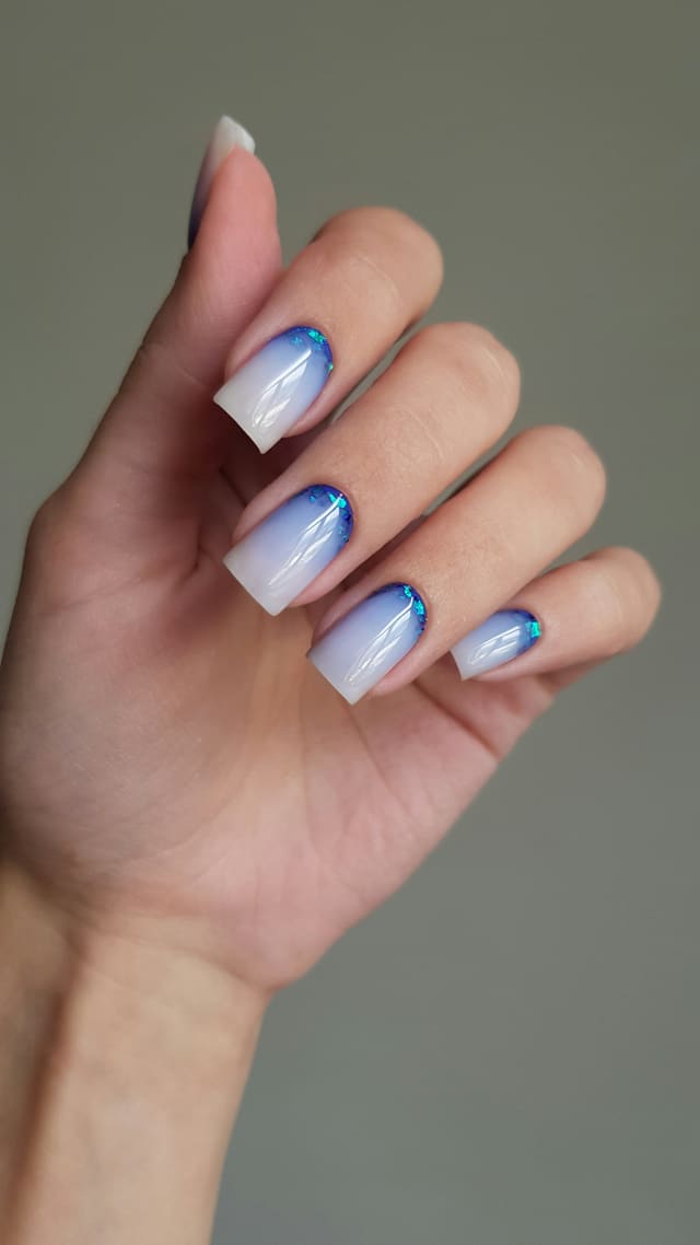 Square nails with blue-to-white ombré and chrome tips