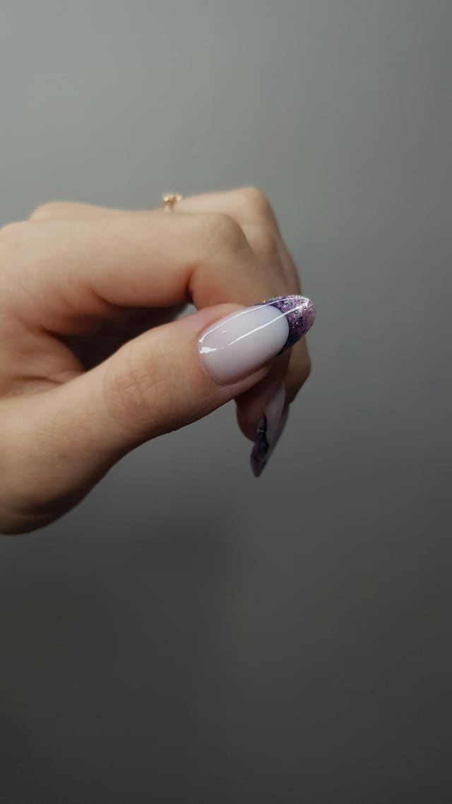 Milky French manicure with a glitter accent